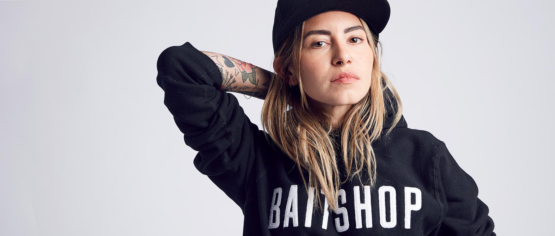 Female model wearing Baitshop premium logo pullover hoodie