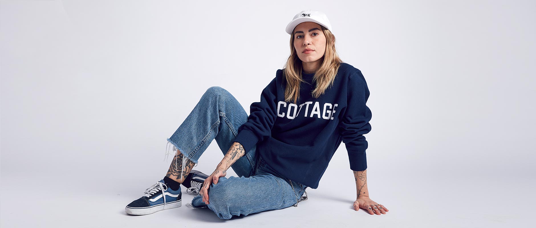 Female model wearing Baitshop Hunting Dad Hat and Cottage Crew neck